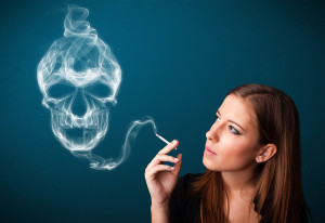 Pretty young woman smoking dangerous cigarette with toxic skull