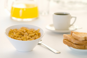 Breakfast table with cereal, toast, coffee and orange juice